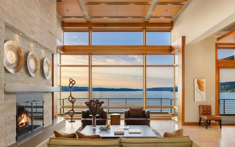 Grand living room with floor-to-ceiling lake views in Bellevue waterfront estate