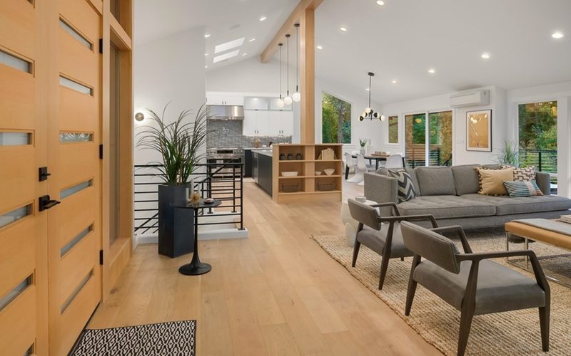 Modern open-concept interior with oak floors and vaulted ceilings in Kirkland