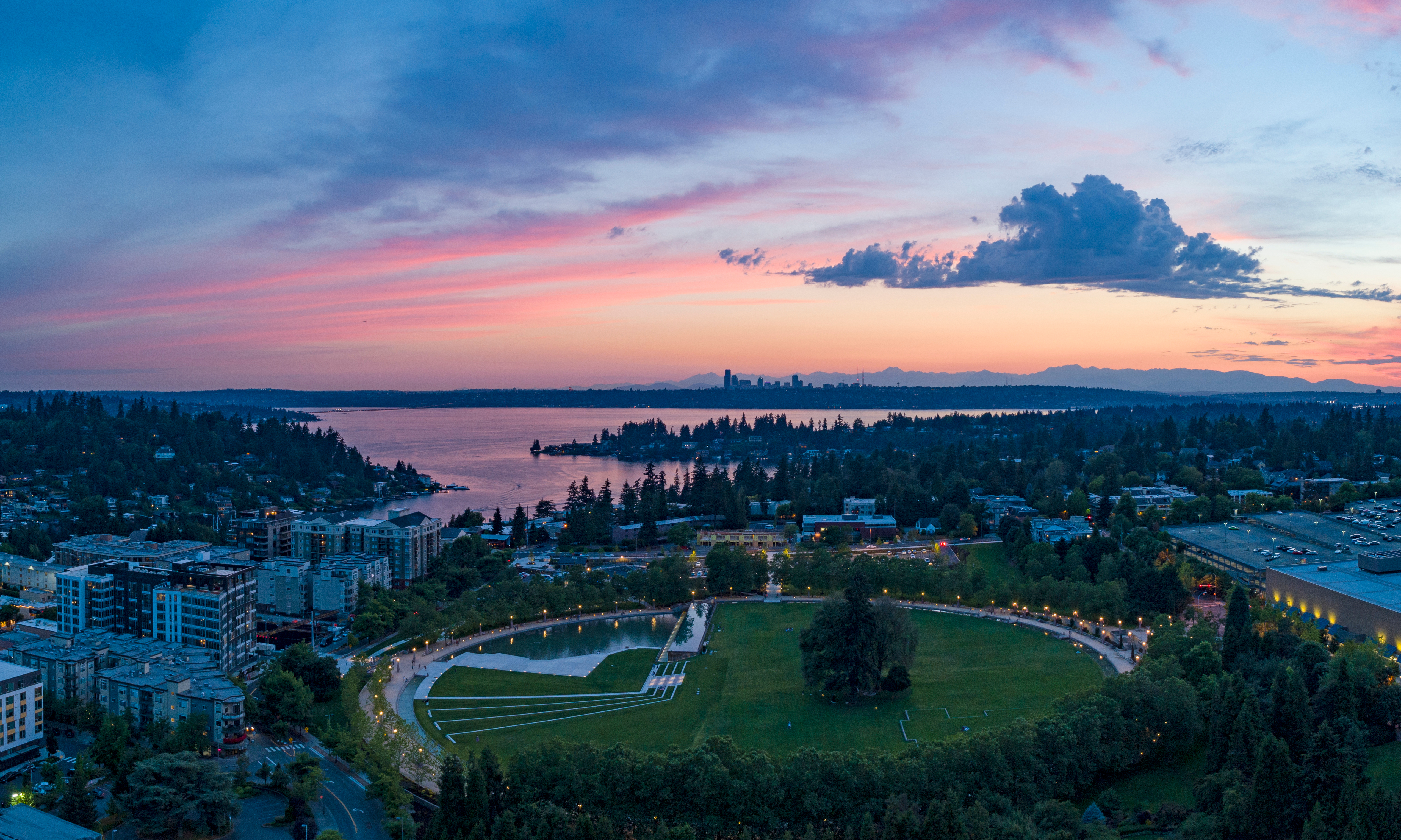 Downtown Bellevue at sunset with Lake Washington and Seattle skyline in the distance
