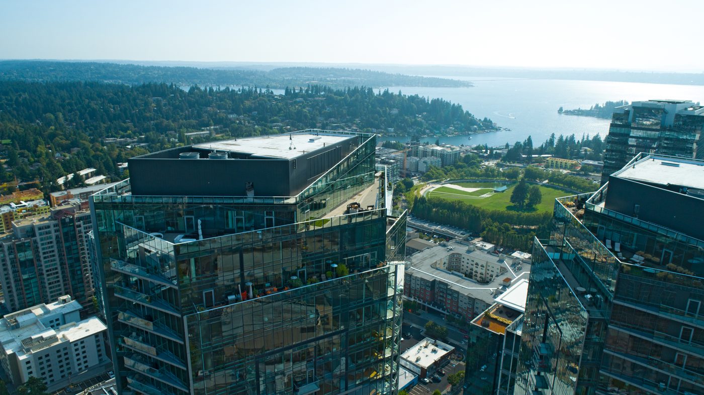Aerial view of Bellevue's glass towers overlooking Downtown Park and Lake Washington