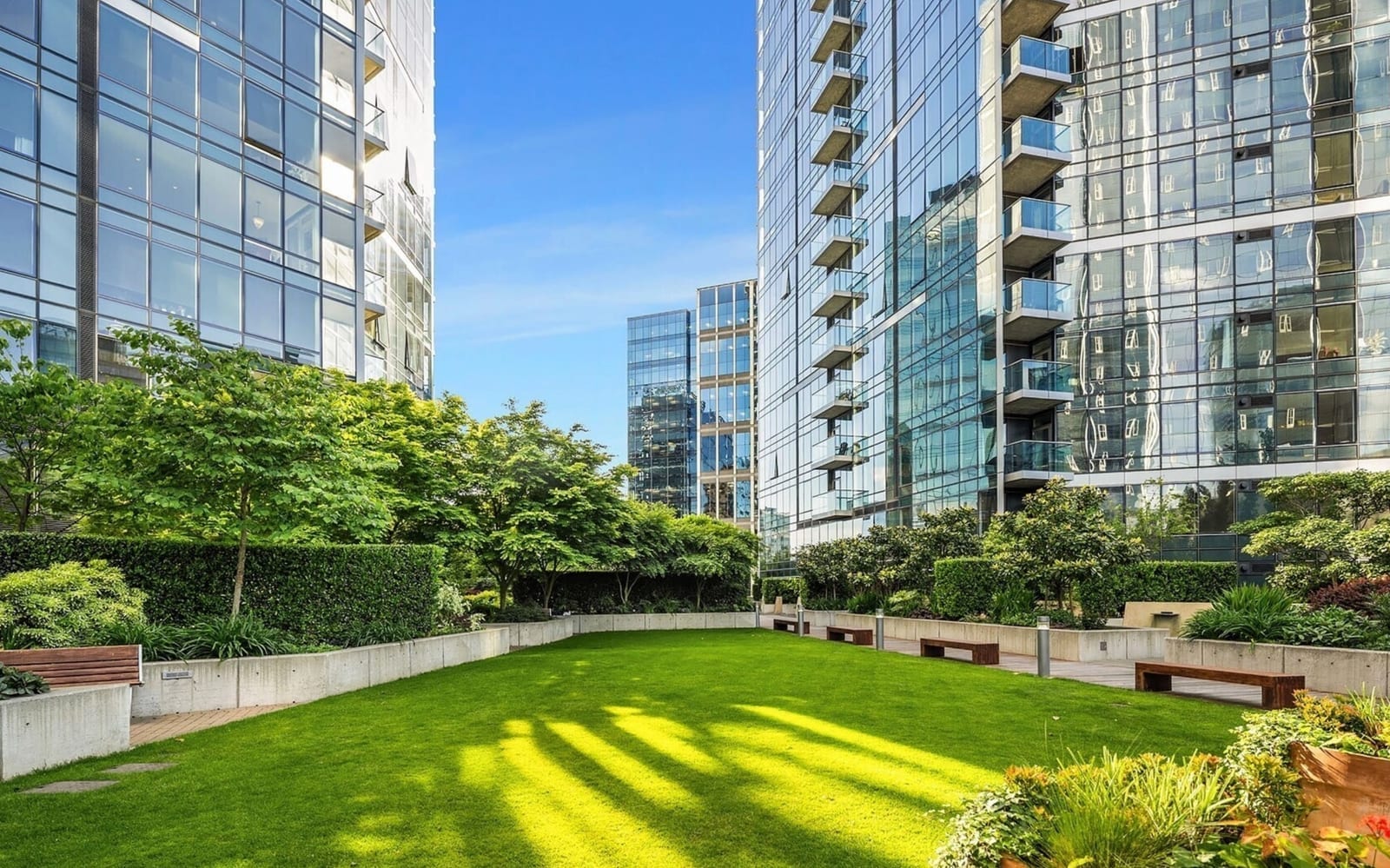 Private half-acre urban garden between the two Bellevue Towers — a landscaped green space with benches and mature plantings