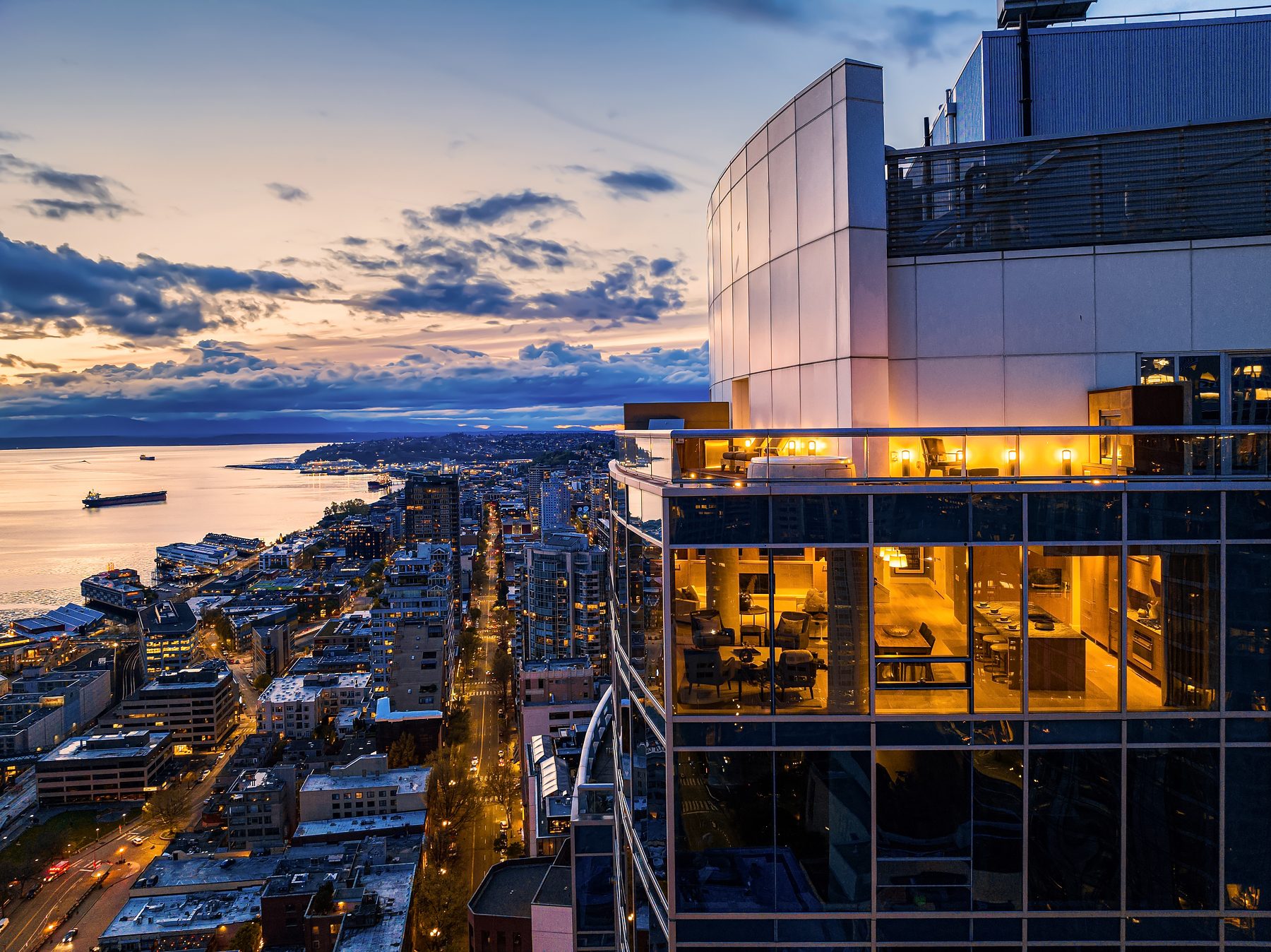 Luxury condo building at dusk with panoramic city views